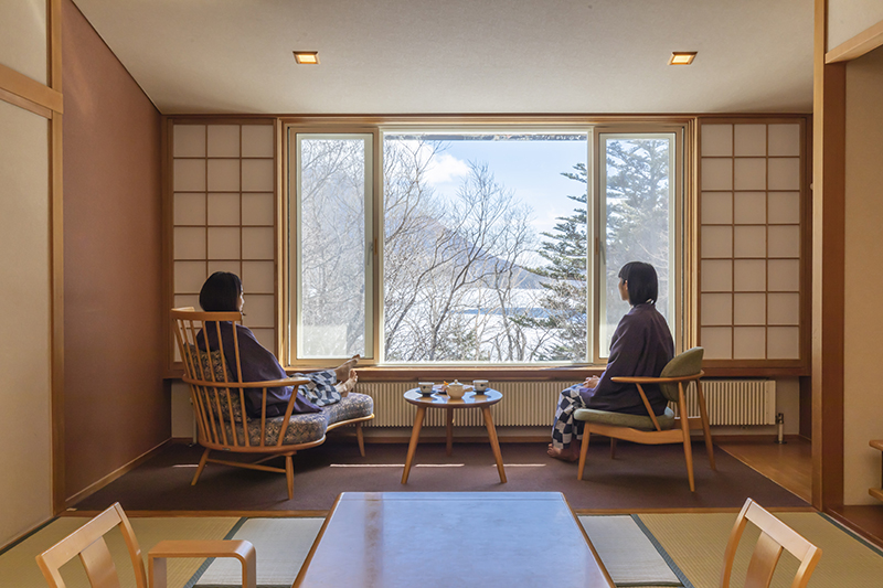 Women looking out at the scenery from a room.